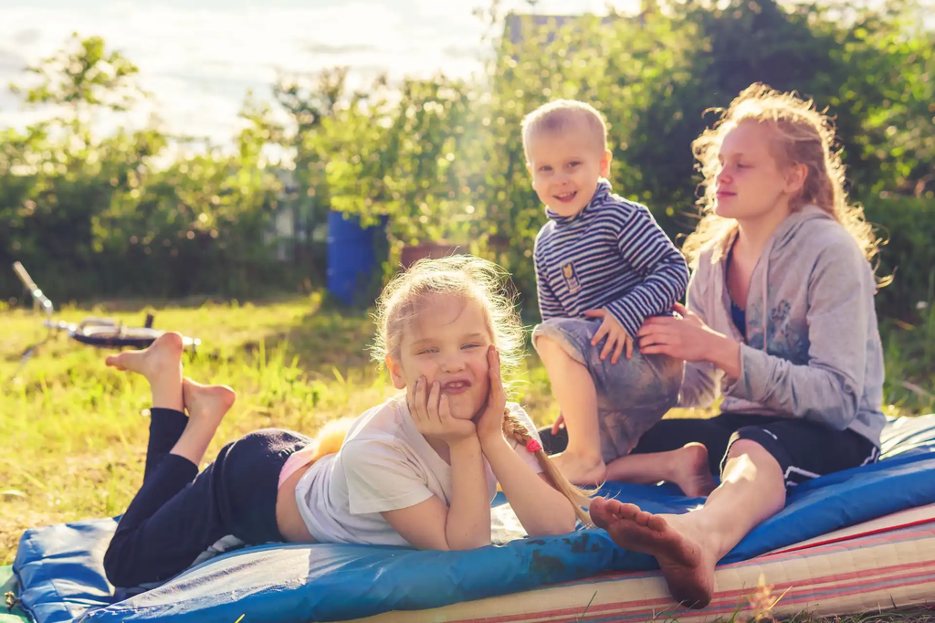 woman-in-black-and-white-striped-shirt-sitting-on-blue-mat